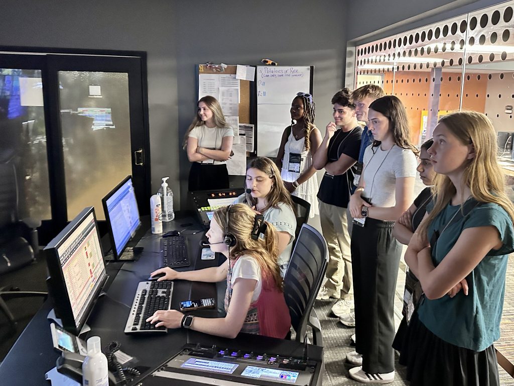 Maya Oleff, left, and Grace Ainger, both seated, produce the 6 p.m. KOMU-TV newscast on June 25, 2025.
